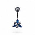 Piercing ombelico in titanio con fiore blu e dettagli luminosi